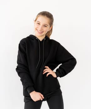 Happy girl in black hoodie smiling wide
