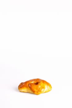 fresh bun with dried apricots on a white photo