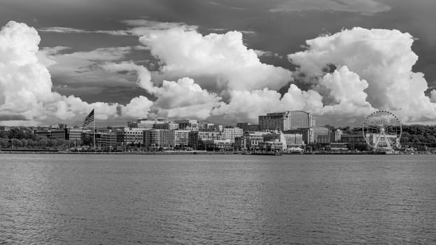 Black and white panorama of the dramatic summer clouds above skyline of National Harbor near Washington DC