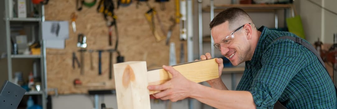 Carpenter measures wooden planks in the workshop