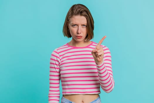 Displeased upset Caucasian woman reacting to unpleasant awful idea, dissatisfied with bad quality, wave hand, shake head No, dismiss idea, dont like proposal. Girl isolated on blue studio background