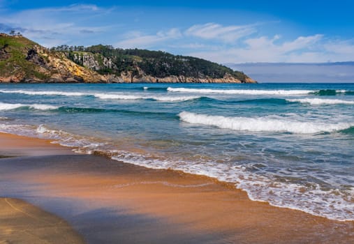 View of Barayo Beach, in the community of Asturias, in summer, with blue sky and light clouds.