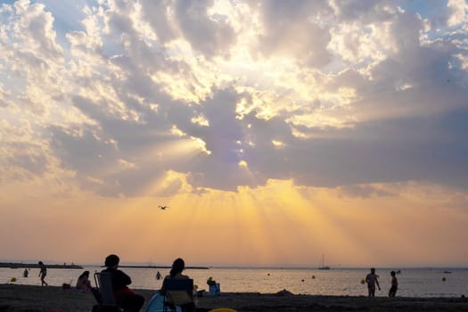 Dramatic sunset and sun rays through the clouds
