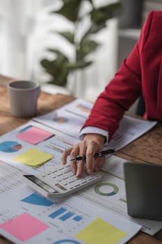 Asian female accountant or banker making calculations. Savings, finances and economy concept...