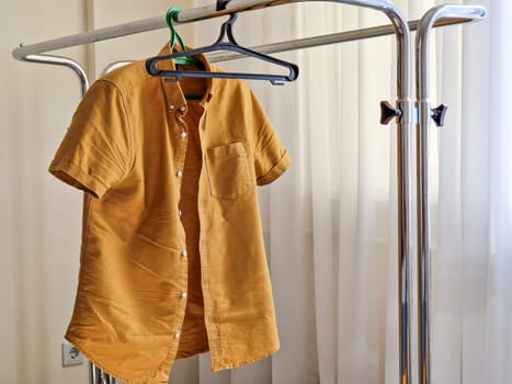 A Hanger with one men shirt. Responsible consumption.