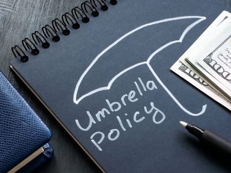 Umbrella policy handwritten on the page and cash.
