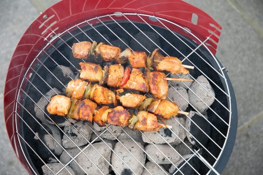 summer picnic with barbecue marinated chicken skewers with grilled vegetables on the terrace, colorful food. High quality photo