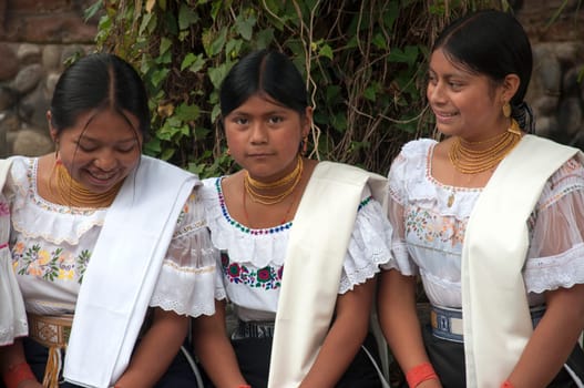 three indigenous friends from the same tribe in traditional otavalo dress enjoying a happy afternoon. High quality photo
