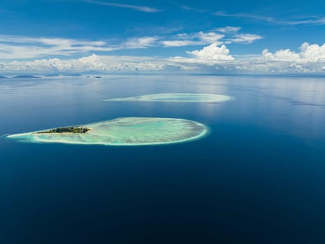Aerial view of island Sibuan with sandy beach and coral reef. Tun Sakaran Marine Park. Borneo, Sabah, Malaysia.
