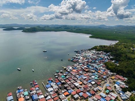 Fishing village with wooden houses on stilts in the sea. Kudat, Sabah, Borneo.