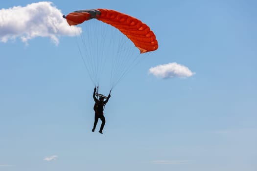 Parachute in the sky. Skydiver is flying a parachute in the blue sky. High quality photo