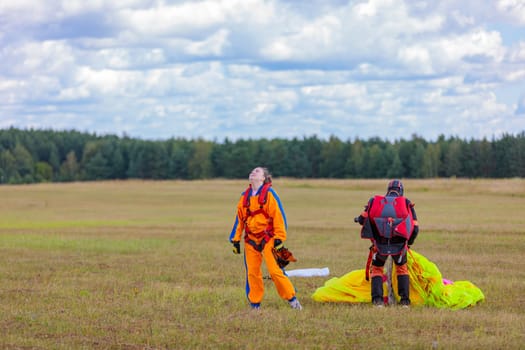 Skydivers-athletes go with a parachute after the jump. High quality photo