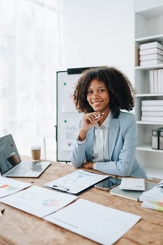 American African business woman using document, computer laptop, calculator, paperwork, documents, in winner and smiling Happy to be successful achievement success. finance and investment concepts.