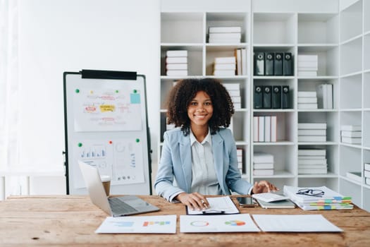 American African business woman using document, computer laptop, calculator, paperwork, documents, in winner and smiling Happy to be successful achievement success. finance and investment concepts.