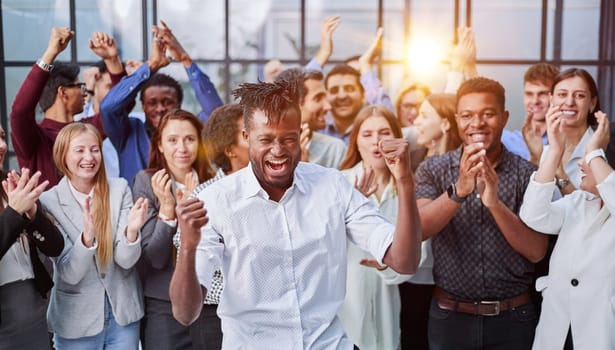 large international group of happy people applauding together standing in the lobby