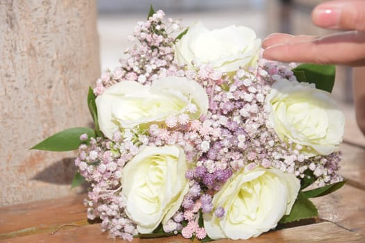 Fresh white and pink flowers bouquet for bride, woman palm, spring wedding photo in light key. High quality photo