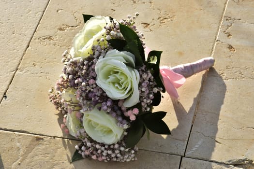Wedding bridal bouquet of flowers of white roses and small pink flowers with leaves. High quality photo