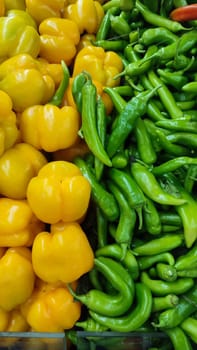 sweet and bitter peppers, and green vegetables summer background, store food. High quality photo
