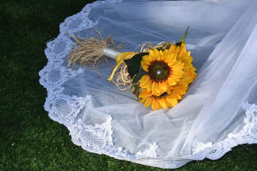 bouquet of yellow sunflower flowers on white wedding dress. High quality photo