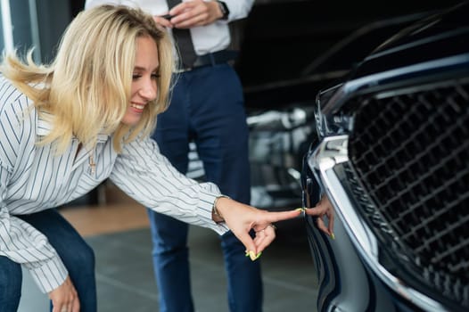 Caucasian couple chooses a new car in a car dealership