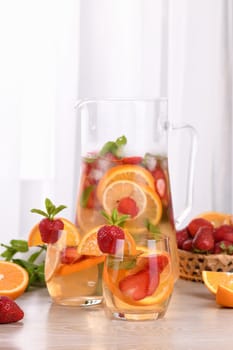 Summer Sangria cocktail or lemonade with strawberry, orange and mint. Refreshing organic non-alcoholic, Detox vitaminized healthy drink, fruit in a glass