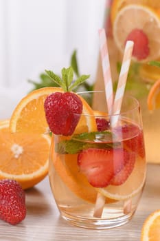 Summer Sangria cocktail or lemonade with strawberry, orange and mint. Refreshing organic non-alcoholic, Detox vitaminized healthy drink, fruit in a glass