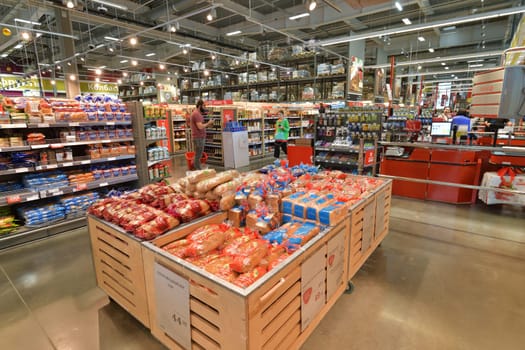 Moscow, Russia - July 10. 2023. Various breads in packaging on counter in Selgros Cash and Carry shop