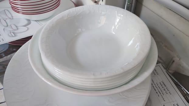 white deep clean plates stacked in a slide,. High quality photo