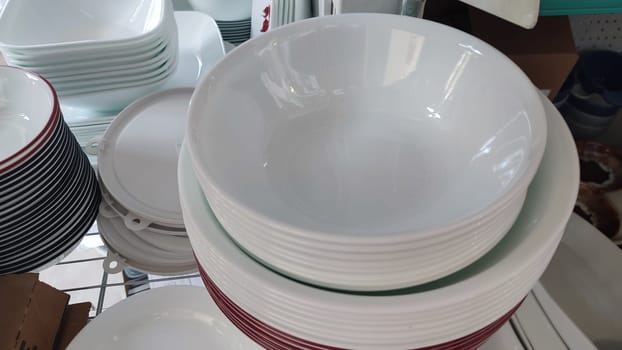 white deep clean plates stacked in a slide,. High quality photo