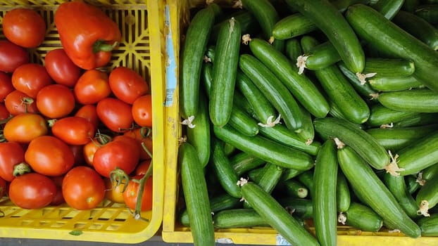 tomatoes and green cucumbers fresh vegetables lie in the grocery store, fresh food, vegetarianism. High quality photo