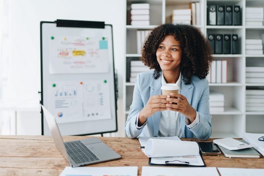 American African business woman using document, computer laptop, calculator, paperwork, documents, in winner and smiling Happy to be successful achievement success. finance and investment concepts.