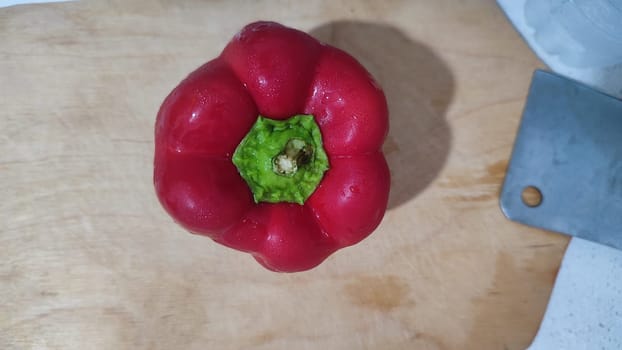 red sweet fresh peppers on the kitchen board, vegetable food. High quality photo