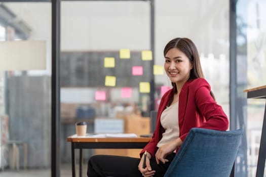 businesswoman smile working in office , sticky papers notes on glass wall, Business design planning concepts.