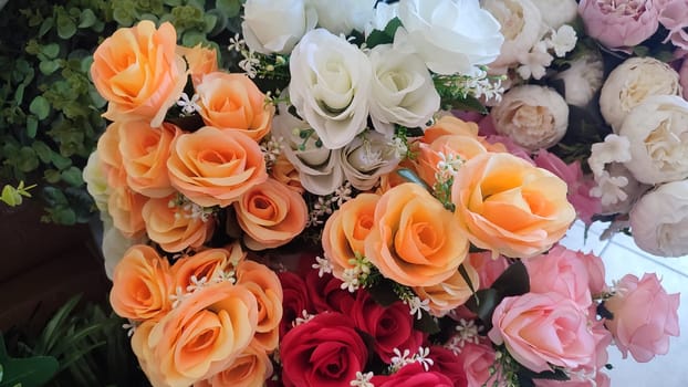 orange and white roses, artificial ornamental plants. High quality photo