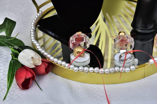 golden wedding rings of newlyweds, bouquet of tulip flowers. High quality photo