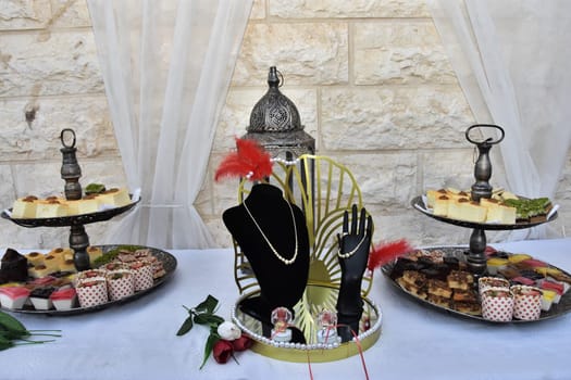 festive dessert on dishes, table with white tablecloth against the wall. High quality photo