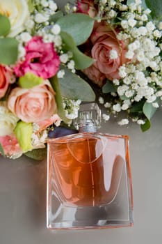 Set bride's accessories: perfume bottle, bride's bouquet. Soft focus.