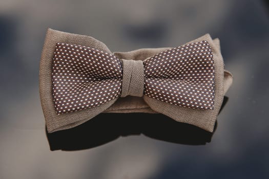 Men's bow tie on a mirror background. Close-up.