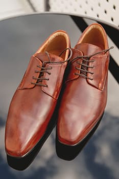 Men's shoes, groom's wedding shoes. Set groom accessories. Soft focus.