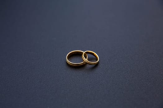 Golden wedding rings on the table. Soft focus.
