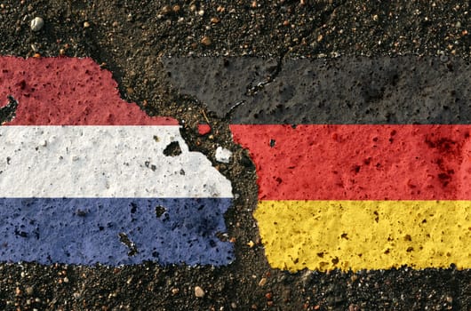 On the pavement, the images of the flags of the Netherlands and China, as a symbol of confrontation. Conceptual image.