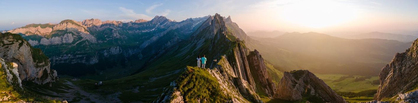 Schaefler mountain ridge swiss Alpstein, Appenzell Switzerland, steep ridge of the majestic Schaefler peak, Switzerland. couple man and woman mid age in the mountains, man and woman hiking 