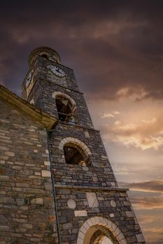 Historical clock tower in Greece, dramatic photo of old clock tower in Pelion, Greece