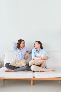 Girlfriends having fun, singing and playing together at home.