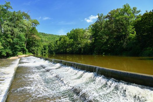 Sluice on the river. Beautiful outdoor nature with running water.