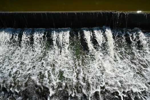 Sluice on the river. Beautiful outdoor nature with running water.