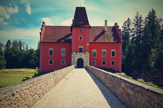 The red chateau Cervena Lhota in the the Czech Republic.
Beautiful old castle in the countryside on a summer day. Colorful nature background.
