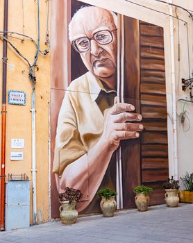 Porto Empedocle, Italy - July 22: View of the Murales tribute to the sicilian writer Andrea Camilleri painted by the street artist Salvo Ligama on July 22, 2021