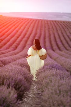 Woman lavender field. Lavender field happy woman in yellow dress in lavender field summer time at sunset.