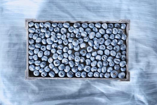 Blueberries  or bilberries in wooden box ,  blue berries  fruit in crate , healthy eating